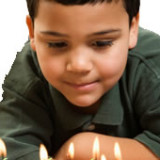 Capital One Wish for Others Launches - Boy Blowing Out Candles